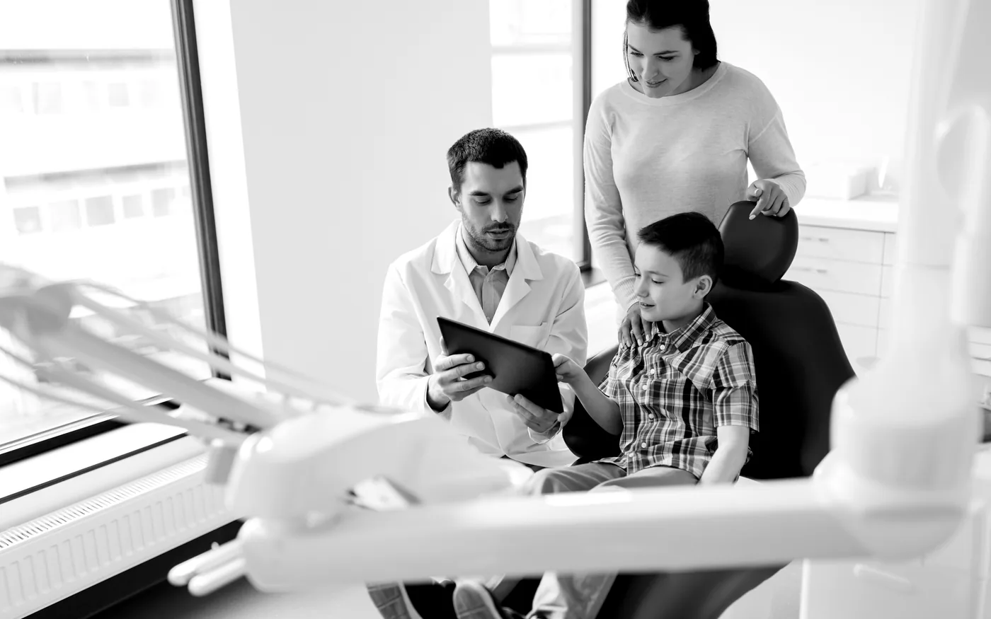 Black-and-white dental consult with a patient family