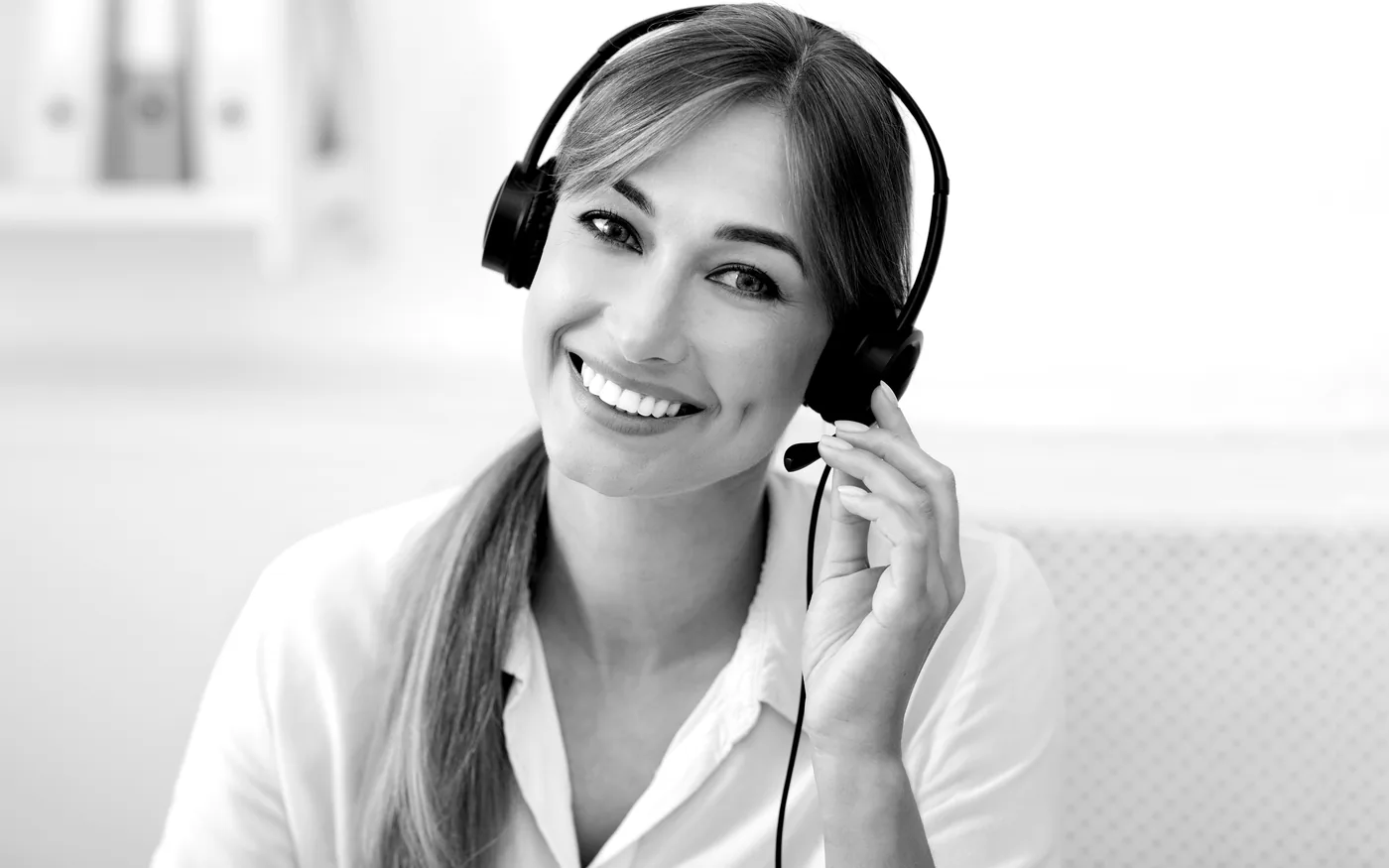 Black-and-white receptionist wearing a headset