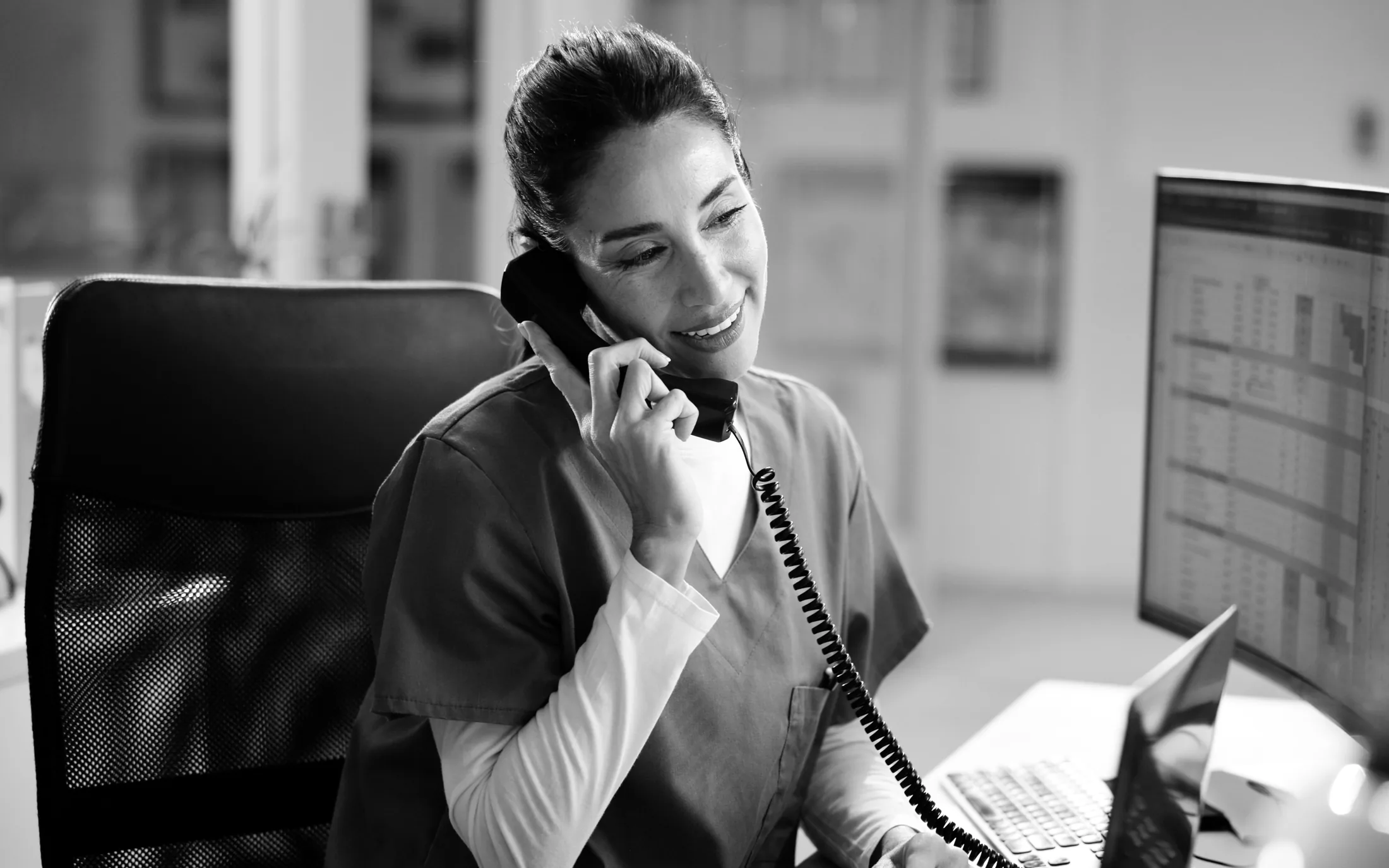 Black-and-white recall specialist calling overdue patients
